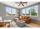 Bright living room with a comfortable leather sofa, area rug, and expansive windows at 7130 Simms St # 206, Arvada, CO 80004