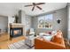 A well-lit living room boasts a fireplace, ceiling fan, and stylish furniture for a cozy ambiance at 7130 Simms St # 206, Arvada, CO 80004