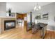 Open-concept living room with kitchen and fireplace, dining area and hardwood floors at 7130 Simms St # 206, Arvada, CO 80004