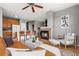 Cozy living room featuring a fireplace, ceiling fan, and an open view to the kitchen at 7130 Simms St # 206, Arvada, CO 80004