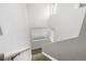 View of a staircase with white walls, handrail, carpeted steps, and a window at 7130 Simms St # 206, Arvada, CO 80004