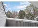 Balcony view of mature snow-covered trees, a street, and an overcast sky at 8701 Huron St # 1-212, Thornton, CO 80260