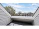 Overhead balcony view, showing the rooftop in the foreground and the treeline in the background at 8701 Huron St # 1-212, Thornton, CO 80260