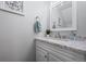 Bathroom showcasing a white vanity with granite countertop and chrome hardware and a framed mirror at 8701 Huron St # 1-212, Thornton, CO 80260
