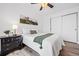 Cozy bedroom with a ceiling fan, mountain art, and natural light from the window at 8701 Huron St # 1-212, Thornton, CO 80260