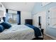 Bedroom featuring built-in shelves, light blue walls, hardwood floors, and an adjacent closet at 8701 Huron St # 1-212, Thornton, CO 80260