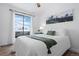 Bright bedroom with a sliding glass door, a hot tub view, and a mountainscape print at 8701 Huron St # 1-212, Thornton, CO 80260