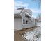 Exterior view of a two-story condo building with stairs and balconies on a snow-dusted lawn at 8701 Huron St # 1-212, Thornton, CO 80260