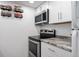 A well-equipped kitchen with stainless steel appliances, granite countertops and a spice rack at 8701 Huron St # 1-212, Thornton, CO 80260