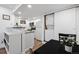 A modern kitchen featuring stainless steel appliances, granite counters, and an adjacent washer-dryer unit at 8701 Huron St # 1-212, Thornton, CO 80260