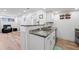 The kitchen showcases granite countertops, stainless appliances, white cabinets, and modern fixtures at 8701 Huron St # 1-212, Thornton, CO 80260