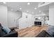 Bright living room showcases hardwood floors, white walls, an entry staircase and an open floor plan at 8701 Huron St # 1-212, Thornton, CO 80260