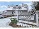 Community sign for Star Point Condominiums with snow, landscaping, and a partial view of the condos at 8701 Huron St # 1-212, Thornton, CO 80260