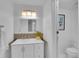 Stylish bathroom with a modern vanity, decorative mirror, and updated fixtures at 2700 S Holly St # 107, Denver, CO 80222