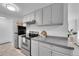 Bright kitchen featuring stainless steel appliances, neutral tones and ample storage at 2700 S Holly St # 107, Denver, CO 80222
