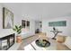 Bright living room featuring a white brick fireplace, and a casual dining area at 2700 S Holly St # 107, Denver, CO 80222