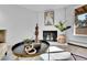 Cozy living room showcasing a brick fireplace, stylish decor, and lots of natural light at 2700 S Holly St # 107, Denver, CO 80222