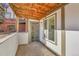 Cozy patio featuring a wood plank ceiling, concrete floor, and secure door at 2700 S Holly St # 107, Denver, CO 80222
