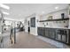 Finished basement area featuring a wet bar with beverage cooler, neutral walls and flooring, and stairwell at 2305 Quitman St, Denver, CO 80212