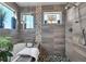 Modern bathroom showcasing a glass enclosed shower with river rock floor, freestanding tub and custom tile work at 2305 Quitman St, Denver, CO 80212