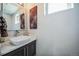 Stylish powder room featuring modern vanity with contemporary sink and lighting fixtures, and decorative wall art at 2305 Quitman St, Denver, CO 80212