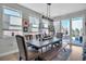 Inviting dining room with large table, stylish chairs, and natural light from big windows and backyard access at 2305 Quitman St, Denver, CO 80212