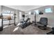 Bright home gym with workout equipment, natural light, and neutral carpet at 2305 Quitman St, Denver, CO 80212