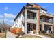 Striking modern home featuring stone accents and a private balcony on a sunny day at 2305 Quitman St, Denver, CO 80212