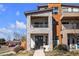 Striking modern home featuring stone accents and a private balcony on a sunny day at 2305 Quitman St, Denver, CO 80212