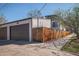 Modern home featuring an attached two-car garage and fenced yard at 2305 Quitman St, Denver, CO 80212