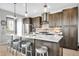 Modern kitchen featuring stainless steel appliances, pendant lighting, and a large center island with barstool seating at 2305 Quitman St, Denver, CO 80212