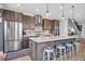 Modern kitchen island featuring stainless steel appliances, custom cabinets, and stylish pendant lights at 2305 Quitman St, Denver, CO 80212