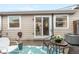 Charming backyard patio with a cozy seating area, accented by a decorative rug and lush potted flowers at 2985 W 46Th Ave, Denver, CO 80211