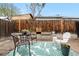 Relaxing backyard with comfortable seating on a leaf-patterned outdoor rug next to a wooden fence and planters at 2985 W 46Th Ave, Denver, CO 80211