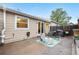 Charming backyard with patio seating area, decorative rug, lush greenery, and privacy fencing at 2985 W 46Th Ave, Denver, CO 80211