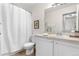 Well-lit bathroom with a shower curtain, vanity, and framed art adds a touch of elegance at 2985 W 46Th Ave, Denver, CO 80211