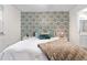 Stylish bedroom with colorful wallpaper, plush bedding, and ample natural light at 2985 W 46Th Ave, Denver, CO 80211