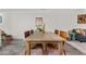 Open-concept dining area with a long, wooden table and modern chairs, perfect for entertaining at 2985 W 46Th Ave, Denver, CO 80211