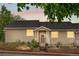 Inviting home exterior featuring a well-maintained front yard, charming porch, and warm, glowing windows at 2985 W 46Th Ave, Denver, CO 80211