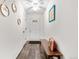 Bright entryway featuring hardwood floors, a ceiling fan, modern artwork and a bench at 2985 W 46Th Ave, Denver, CO 80211
