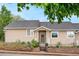Inviting single-story home with landscaped garden, a covered porch and mature trees providing shade at 2985 W 46Th Ave, Denver, CO 80211