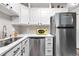 Well-lit kitchen with stainless steel appliances, gray backsplash, and efficient counter space at 2985 W 46Th Ave, Denver, CO 80211