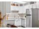 Bright kitchen with stainless steel appliances, white cabinets, and neutral subway tile backsplash at 2985 W 46Th Ave, Denver, CO 80211