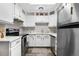Modern kitchen featuring white cabinetry, sleek appliances, and ample counter space for cooking at 2985 W 46Th Ave, Denver, CO 80211