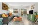 Relaxing living room with a cozy couch, stylish decor, and view of the private backyard at 2985 W 46Th Ave, Denver, CO 80211