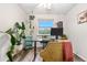 Inviting home office with a scenic window view, complemented by lush greenery and a cozy chair at 2985 W 46Th Ave, Denver, CO 80211