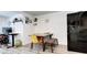 Dining area featuring a wood table, yellow chairs, a bench, and a black refrigerator at 2852 W Ellsworth Ave, Denver, CO 80219