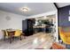 Open kitchen and dining area with green cabinets, stainless steel appliances, and gray wood floors at 2852 W Ellsworth Ave, Denver, CO 80219