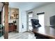 Well-lit living room featuring a dedicated workspace and attractive wood-look floors at 2852 W Ellsworth Ave, Denver, CO 80219