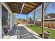 View of a backyard with a small patch of green grass and covered patio at 17476 E Bellewood Cir, Aurora, CO 80015